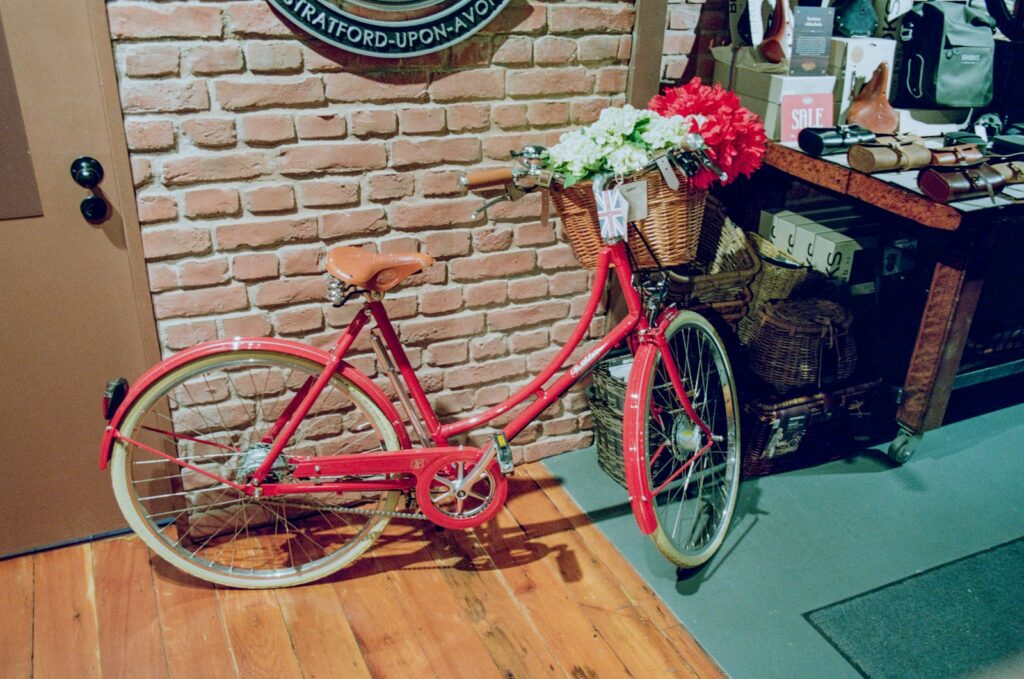 a red bicycle parked next to a brick wall