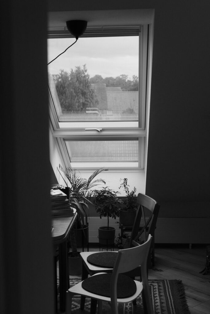 a black and white photo of a chair and a table