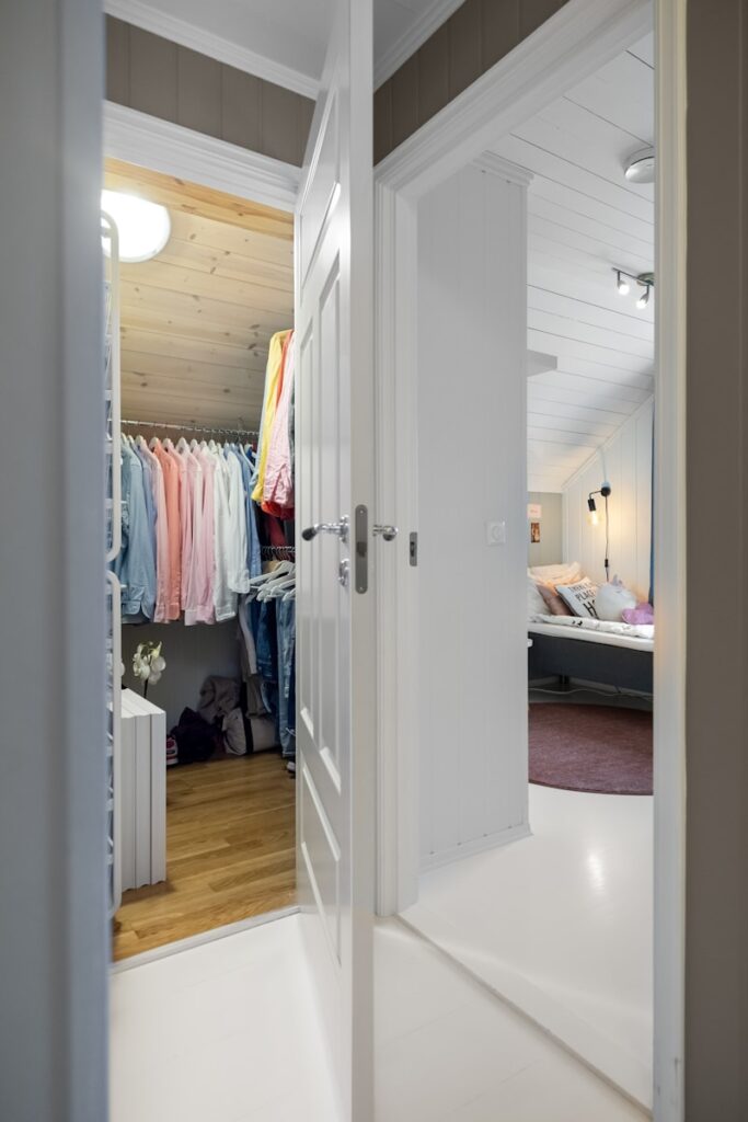 An open door leading to a bedroom with a closet