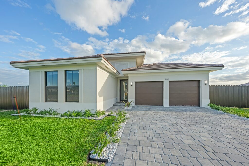 Modern house with a paved driveway and garage.